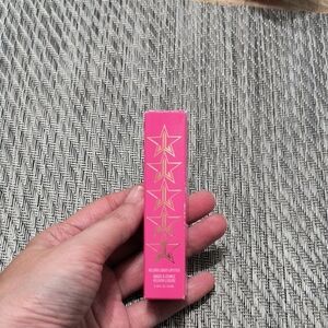 Jeffree Star Vibrant Pink Lipstick Packaging with Gold Stars